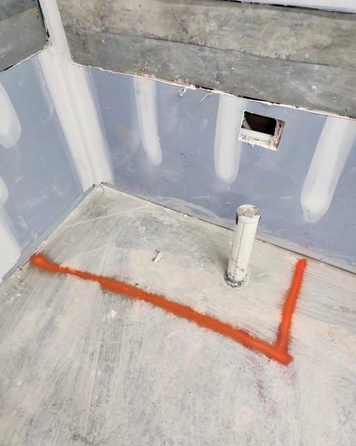 Concrete slab marked in paint around a drain line